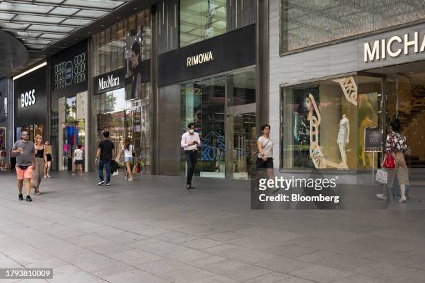 Pedestrians pass window displays on Orchard Road in Singapore, on Monday, Nov. 20, 2023. Singapore's gross domestic product figures for the third...