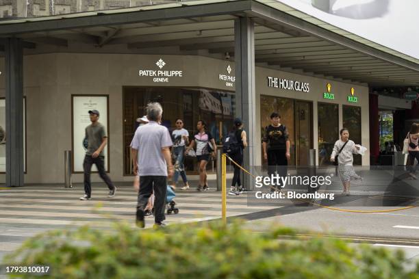 Pedestrians cross a road on Scotts Road in Singapore, on Monday, Nov. 20, 2023. Singapore's gross domestic product figures for the third quarter are...