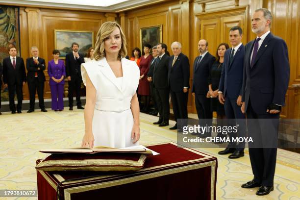 Spain's Minister of Education Pilar Alegria takes an oath on the constitution in front on Spain's King Felipe VI during a ceremony for the...