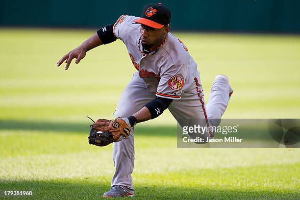 Second baseman Alexi Casilla of the Baltimore Orioles fields a ground ball hit by Carlos Santana of the Cleveland Indians for an out to end the...