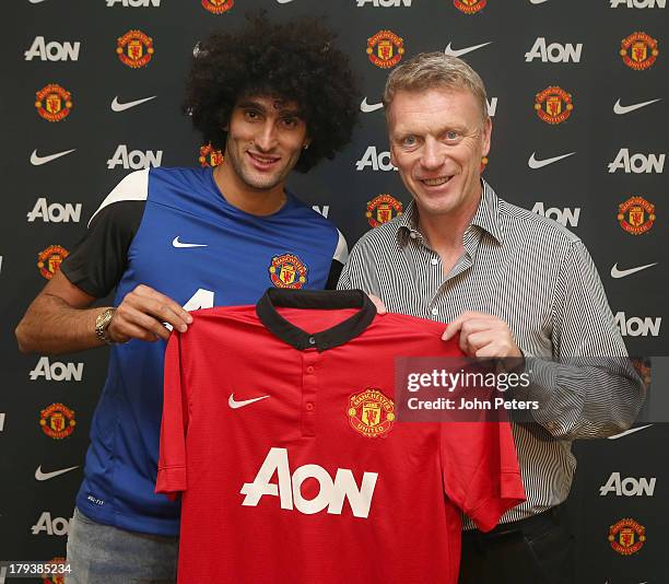 Marouane Fellaini of Manchester United poses with Manager David Moyes after signing for the club at Aon Training Complex on September 2, 2013 in...