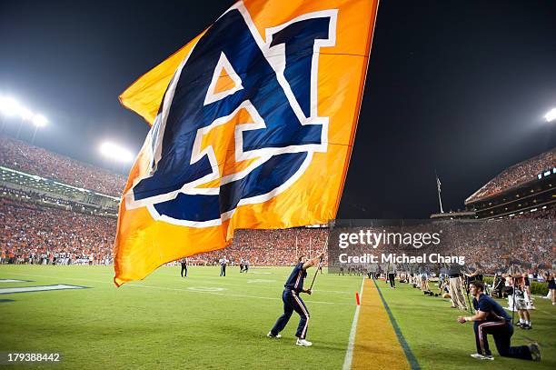 Auburn cheerleaders wave their flag after scoring against the Washington State Cougars on August 31, 2013 at Jordan-Hare Stadium in Auburn, Alabama....