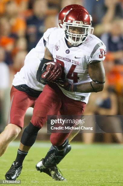 Running back Teondray Caldwell of the Washington State Cougars runs the ball downfield during their game against the Auburn Tigers on August 31, 2013...