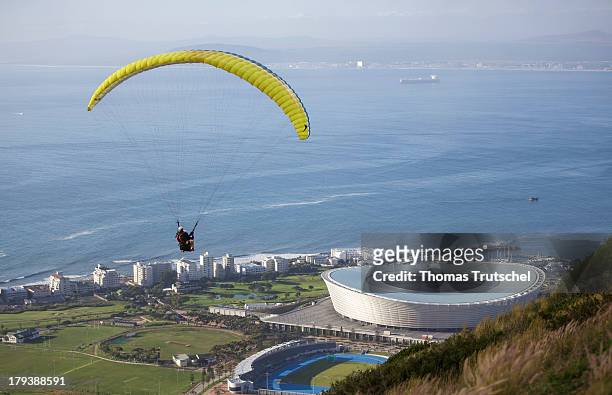 Paraglider descending over the Cape Town Stadium with a view of the sea in the background pictured on April 28, 2013 in Cape Town, South Africa.