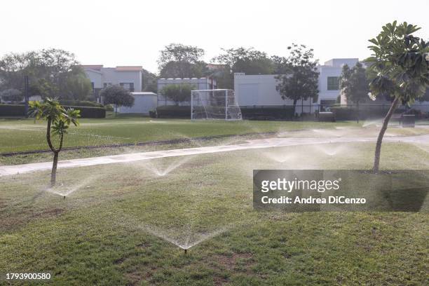 Sprinklers water lawns inside a gated community on November 21, 2023 in Dubai, United Arab Emirates. In the UAE, where 42 percent of water is sourced...