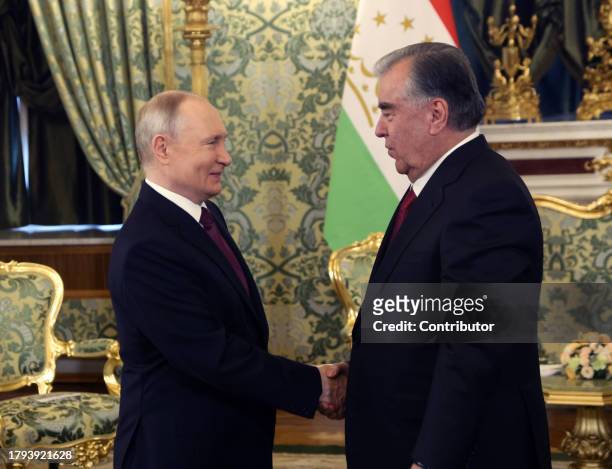 Russian President Vladimir Putin greets Tajik President Emomali Rakhmon at the Grand Kremlin Palace on November 21 in Moscow, Russia. President of...