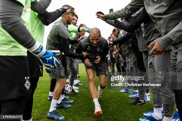 The Team of Borussia welcomes Stefan Lainer back to training after recovering from cancer during a training session of Borussia Moenchengladbach at...