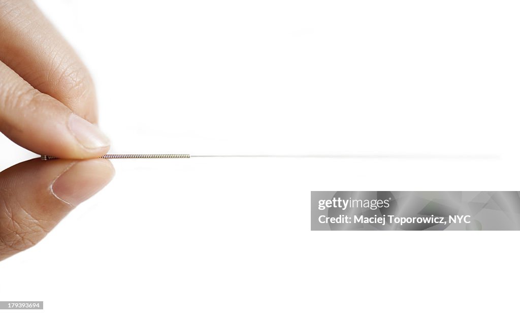 Hand holding acupuncture needle
