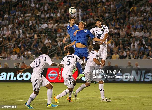 Clarence Goodson and Steven Lenhart of San Jose Earthquakes and Omar Gonzalez of Los Angeles Galaxy vie for the corner kick in the first half during...
