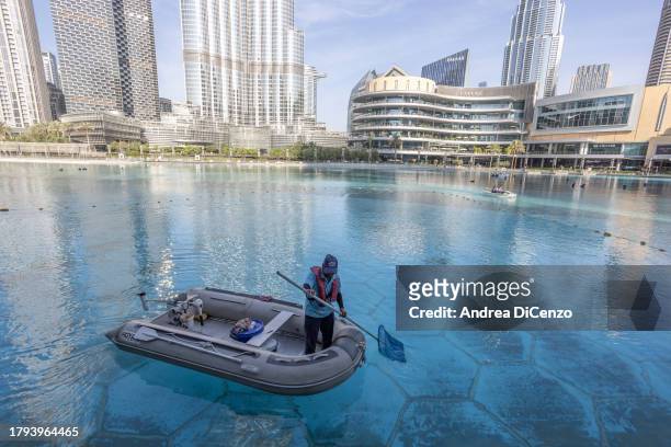 Workers clean the fresh water pool outside Dubai Mall on November 15, 2023 in Dubai, United Arab Emirates. In the UAE, where 42 percent of water is...