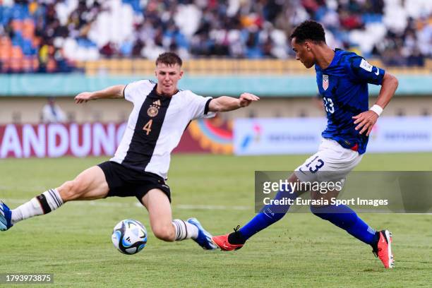 Peyton Miller of United States passes the ball while is blocked by Finn Jeltsch of Germany during FIFA U-17 World Cup Round of 16 match between...