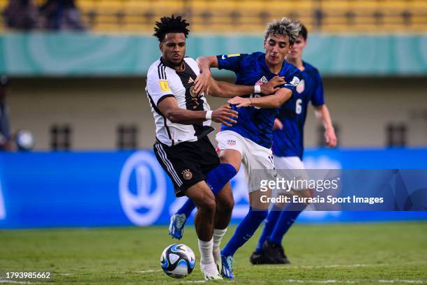 Cruz Medina of United States fights for the ball with Almugera Kabar of Germany during FIFA U-17 World Cup Round of 16 match between Germany and USA...