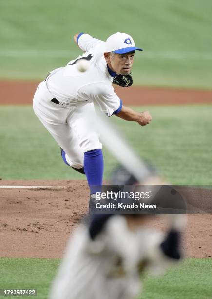 Former Seattle Mariners outfielder Ichiro Suzuki pitches during a game between his amateur baseball team Kobe Chiben and a team of selected high...