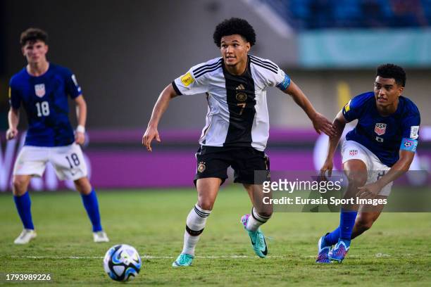 Paris Brunner of Germany is chased by Pedro Soma of United States during FIFA U-17 World Cup Round of 16 match between Germany and USA at Si Jalak...