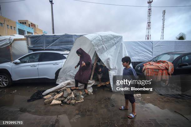 Displaced Palestinian family in a temporary shelter at a camp, operated by the United Nations Relief and Works Agency , in Khan Younis, Gaza, on...