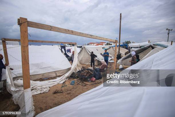 Displaced Palestinians prepare a temporary shelter at a camp, operated by the United Nations Relief and Works Agency , in Khan Younis, Gaza, on...