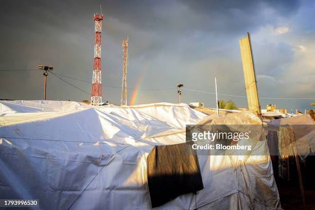 Rainbow forms after a rain shower beyond temporary shelters at a camp for displaced Palestinians, operated by the United Nations Relief and Works...