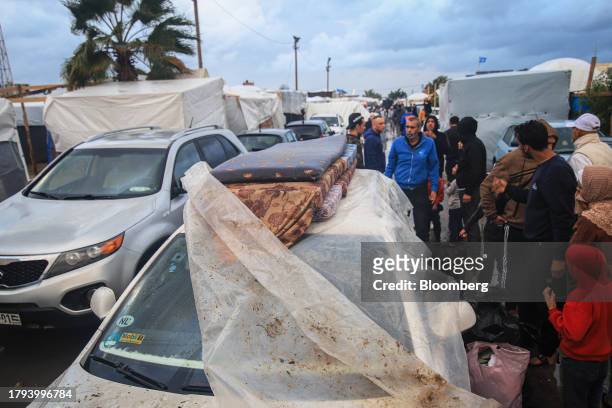 Bedding materials for displaced Palestinians on the roof of a vehicle at a temporary camp, operated by the United Nations Relief and Works Agency ,...