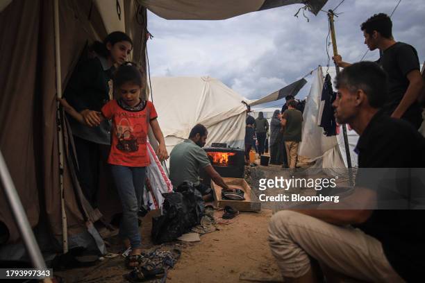 Displaced Palestinians in temporary shelters at a camp, operated by the United Nations Relief and Works Agency , in Khan Younis, Gaza, on Sunday,...