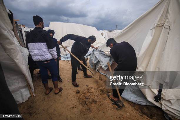 Displaced Palestinians prepare a temporary shelter at a camp, operated by the United Nations Relief and Works Agency , in Khan Younis, Gaza, on...