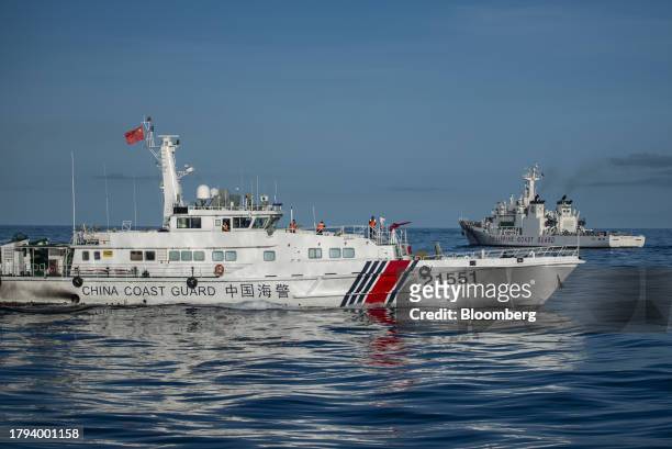 China Coast Guard ship moves past a Philippine Coast Guard ship, during a resupply mission for the BRP Sierra Madre, in the Second Thomas Shoal in...