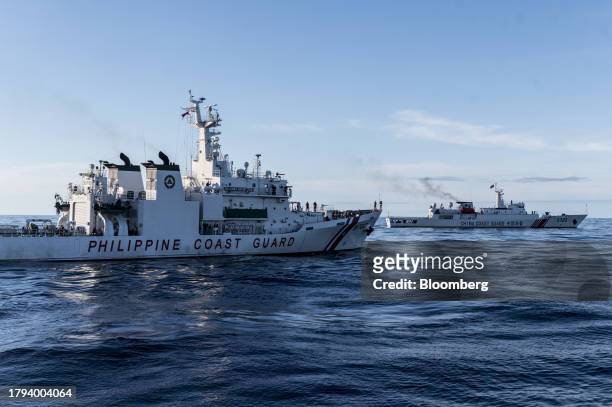 Philippine Coast Guard ship near a China Coast Guard ship, during a resupply mission for the BRP Sierra Madre, in the Second Thomas Shoal in the...