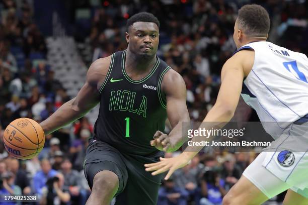 Zion Williamson of the New Orleans Pelicans drives against Dante Exum of the Dallas Mavericks during the first half of the the NBA In-Season...