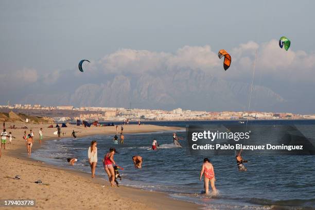 Bathers enjoying the beach while Africa is seen in the distance on August 30, 2013 in Tarifa, Spain. Despite Europe's financial crisis illegal...