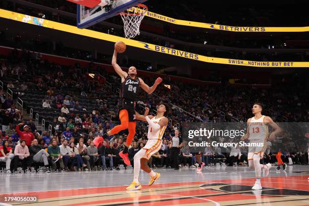 Kevin Knox II of the Detroit Pistons tries to get a shot off next to Jalen Johnson of the Atlanta Hawks during the second half of an NBA In-Season...