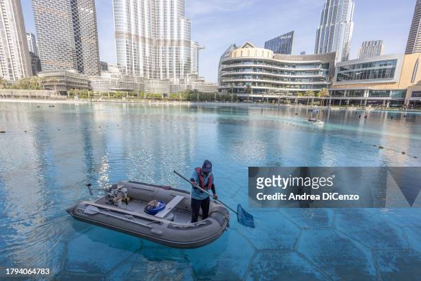 Workers clean the fresh water pool outside Dubai Mall on November 15, 2023 in Dubai, United Arab Emirates. In the UAE, where 42 percent of water is...