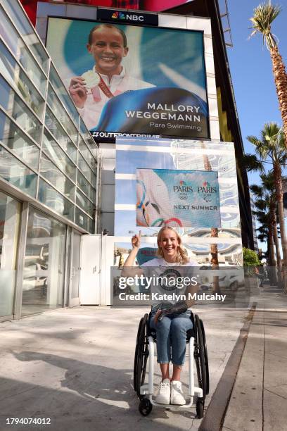 Paralympian Mallory Weggemann of Lawrence, Kansas, poses for a picture with her sign on the Sunset Strip during the Team USA Road to Paris Bus Tour...