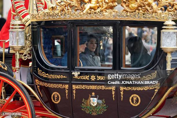 Britain's Queen Camilla and South Korea's First Lady Kim Keon Hee travel in a carriage, during a carriage procession along The Mall to Buckingham...