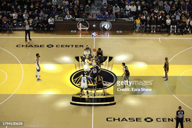Draymond Green of the Golden State Warriors and Rudy Gobert of the Minnesota Timberwolves go for the jump ball at Chase Center on November 14, 2023...