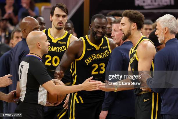 Klay Thompson and Draymond Green of the Golden State Warriors complain to the referee after getting into an altercation with the Minnesota...