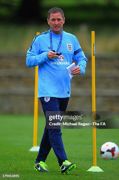 Coach Steve Holland looks on during the U21 training session at St Georges Park on September 3, 2013 in Burton-upon-Trent, England.