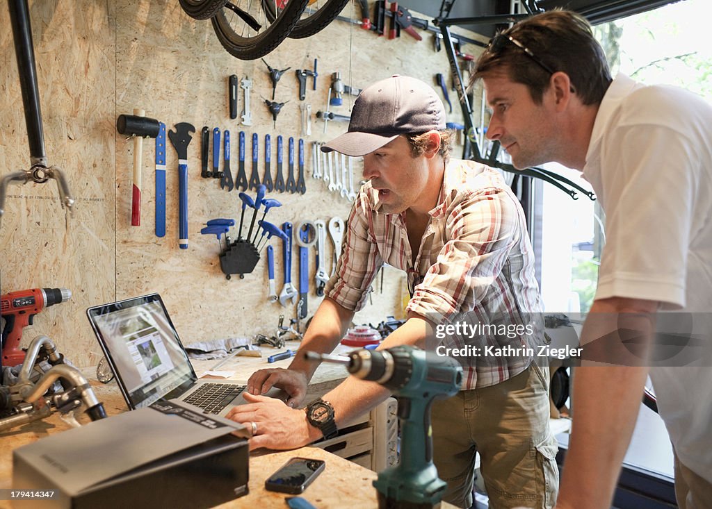 Bike shop owner discussing products with client