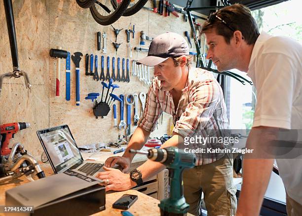bike shop owner discussing products with client