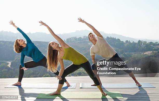 family practicing yoga together - legs apart imagens e fotografias de stock