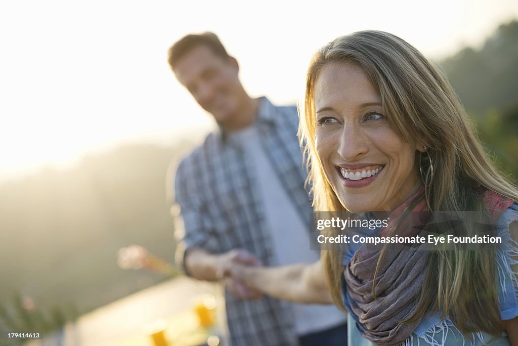 Smiling couple holding hands outdoors