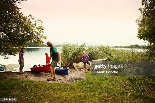 family at a lake with canoes - murnau stock pictures, royalty-free photos & images