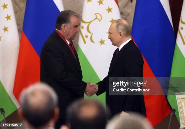 Russian President Vladimir Putin shakes hands with Tajik President Emomali Rakhmon during the meeting at the Grand Kremlin Palace, on November 21,...