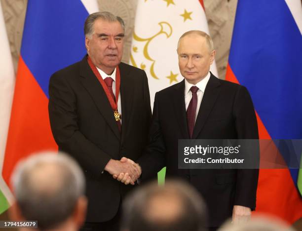 Russian President Vladimir Putin shakes hands with Tajik President Emomali Rakhmon during the meeting at the Grand Kremlin Palace, on November 21,...