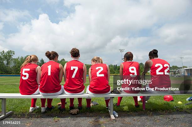 rear view of girls' softball team on bench - number 14 stockfoto's en -beelden