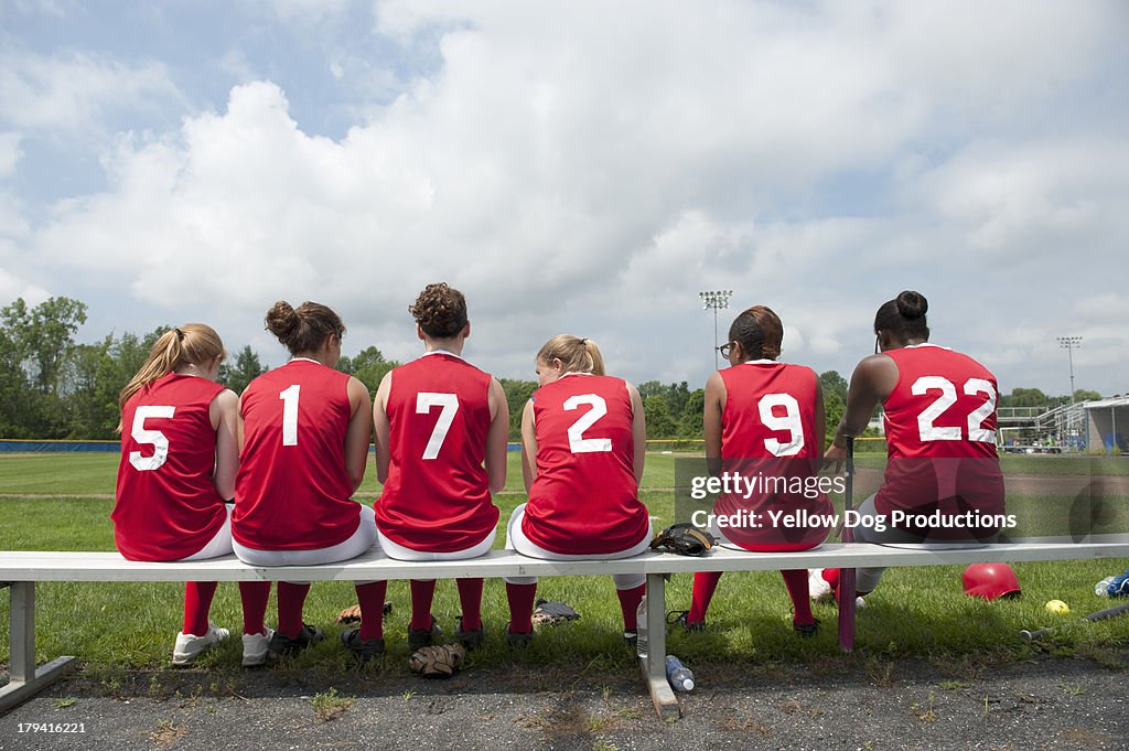 Rear View of Girls' Softball Team on Bench