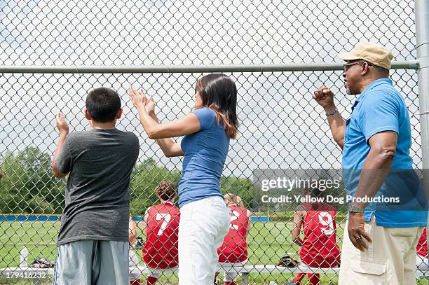 family members cheering  players on sidelines - blonde cheering stock-fotos und bilder