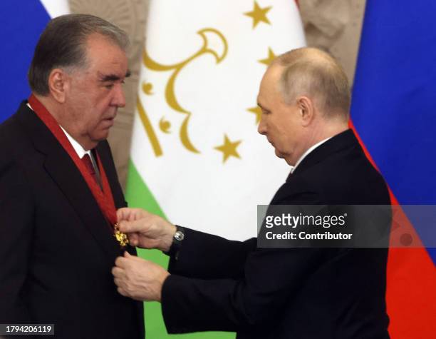 Russian President Vladimir Putin awards Tajik President Emomali Rakhmon with the "Order for Services To The Fatherland" during the meeting at the...
