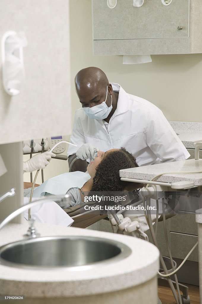 Dental office. Working on a teenage patient