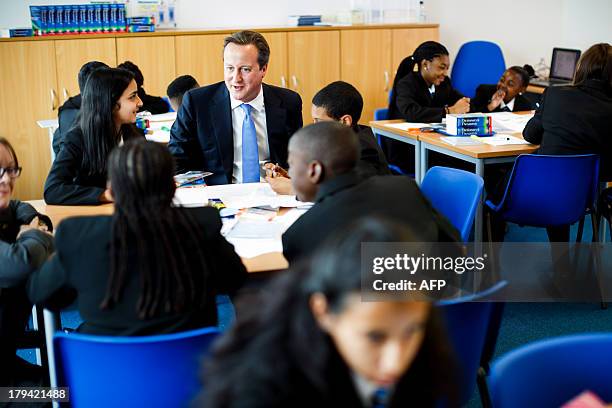 Britain's Prime Minister David Cameron interacts with students during his visit to the opening of the Perry Beeches III Free School in Birmingham on...