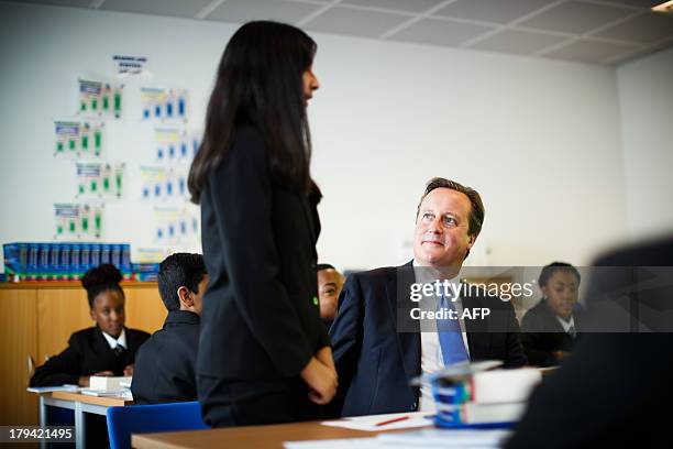 Britain's Prime Minister David Cameron interacts with students during his visit to the opening of the Perry Beeches III Free School in Birmingham on...