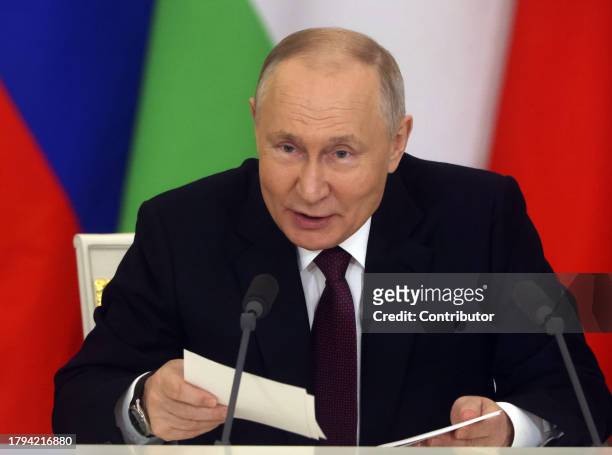 Russian President Vladimir Putin holding his papers talks during Russian-Tajik talks at the Grand Kremlin Palace, on November 21, 2023 in Moscow,...